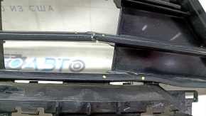 The lower grille of the front bumper, central, VW Tiguan 18-21, under parking sensors, R-Line, is cracked, chipped, and sanded.