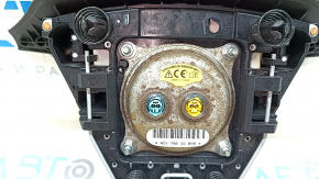 The steering wheel airbag for the driver's side of the Hyundai Santa FE Sport 13-18 is black and rusty.