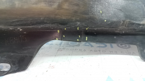 Right front bumper guard for Mazda 3 19-24 4d is torn and worn.