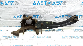 The rear left axle of a Ford Escape MK3 13-19 with a trailing arm is rusty.