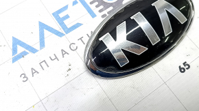 The KIA emblem badge on the front bumper of the Kia Niro 17-22 has swollen paint.