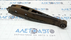 The lower rear left control arm of a Subaru Outback 15-19 is rusty.