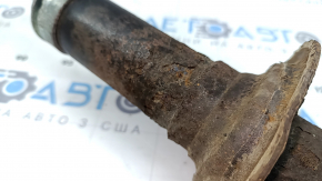 The rear left shock absorber for a Subaru Outback 15-17 is rusty.
