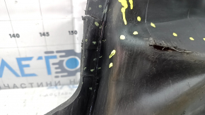 The front bumper guard on the left Mazda 3 19-24 4d is torn, worn, has cracks and tears.