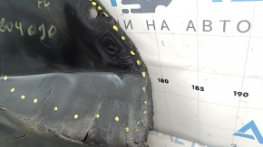 The front bumper guard on the left Mazda 3 19-24 4d is torn, worn, has cracks and tears.