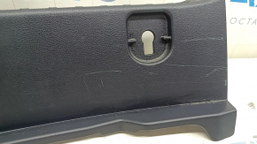 The trunk opening trim for a Toyota Prius 50 16-22 is black, worn, and has scratches.