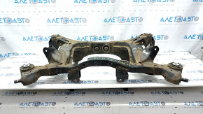 The rear subframe of a 1919 Subaru Outback is rusty.