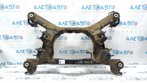 The rear subframe of a 1919 Subaru Outback is rusty.