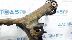 The rear subframe of a 1919 Subaru Outback is rusty.