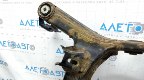 The rear subframe of a 1919 Subaru Outback is rusty.