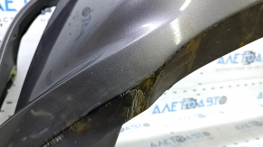 The front bumper of a Toyota Camry V55 2015-2017 (USA) is cracked, dented, and has scratches.