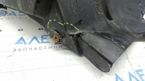 The front right rear fender liner of a BMW X5 F15 14-18 is dented and the fastener is torn.