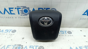 The airbag in the driver's steering wheel of a Toyota Prius 50 16-22 is black and scratched.