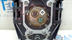 The airbag in the driver's steering wheel of a Toyota Prius 50 16-22 is black and scratched.
