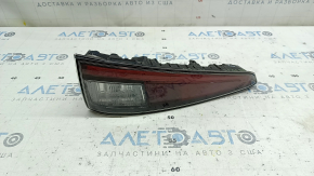 The lower left bumper light of a Toyota Prius 50 16-18 has dirty glass on the inside.