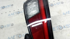 The lower left bumper light of a Toyota Prius 50 16-18 has dirty glass on the inside.