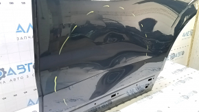 The bare rear left door of a Volvo XC60 18-25 blue 723, dented
