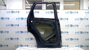 The bare rear left door of a Volvo XC60 18-25 blue 723, dented