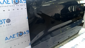The front left door of a Volvo XC60 18-25 blue 723 is bare and dented.