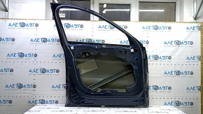 The front left door of a Volvo XC60 18-25 blue 723 is bare and dented.