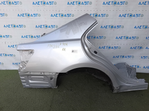 The quarter panel of the rear right Toyota Camry v40 is sawed off, silver, rusty, with bumps.