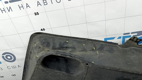 The front left underbody protection of Toyota Venza 21-24 is dented and scuffed.