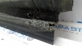 The left underbody protection of the Audi A4 B8 08-16 is large, scuffed, and torn.