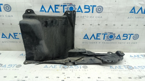 The left side engine guard of a Toyota Prius 50 16-18 is worn and torn.