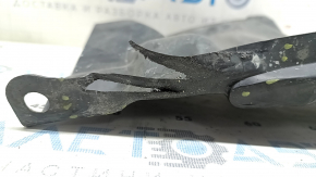 The left side engine guard of a Toyota Prius 50 16-18 is worn and torn.