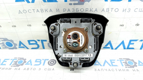 The driver's side airbag in the steering wheel of a Toyota Highlander 20-21 is black, the squib is rusty, the chrome on the emblem is peeling.