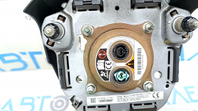 The driver's side airbag in the steering wheel of a Toyota Highlander 20-21 is black, the squib is rusty, the chrome on the emblem is peeling.