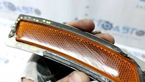 The front left reflector of the BMW 3 F30 16-18 has come unglued and is worn out.