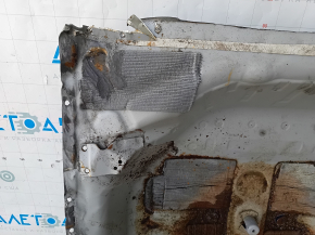The trunk trough of the Honda Accord 23-24 is drilled out, dented, and has tears.