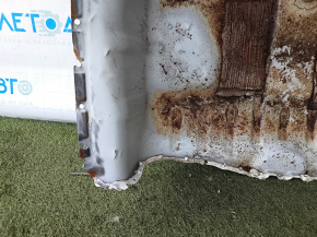 The trunk trough of the Honda Accord 23-24 is drilled out, dented, and has tears.
