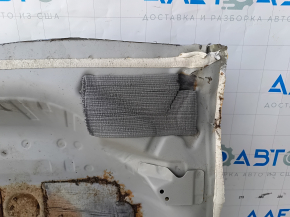 The trunk trough of the Honda Accord 23-24 is drilled out, dented, and has tears.