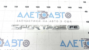 The emblem inscription SPORTAGE FE on the trunk door of the Kia Sportage 17-19