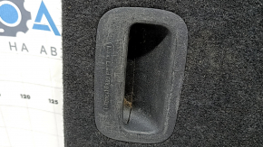 The trunk floor of a Kia Sportage 17-22 is black, with scratches on the handle.