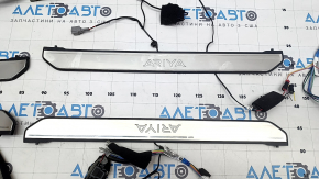 A set of door sills for the Nissan Ariya 23-25, black with chrome insert and backlighting.