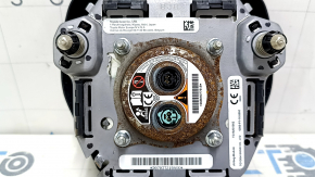The driver's side airbag in the Toyota Camry V70 18-24 is black and has a rusty squib.