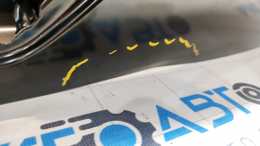 The trunk door of a Ford Edge 19-24 is bare and dented.
