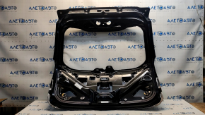 The trunk door of a Ford Edge 19-24 is bare and dented.