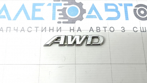 The "AWD" emblem on the rear left door of a Toyota Rav4 19-24.