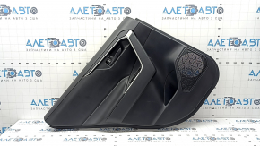 The door trim panel, rear left, Toyota Rav4 19-24, is black, the armrest is black leather, the insert is black plastic, the molding with the handle is gray, scratches are visible.