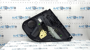The door trim panel, rear left, Toyota Rav4 19-24, is black, the armrest is black leather, the insert is black plastic, the molding with the handle is gray, scratches are visible.