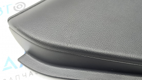 The door trim panel, rear left, Toyota Rav4 19-24, is black, the armrest is black leather, the insert is black plastic, the molding with the handle is gray, scratches are visible.