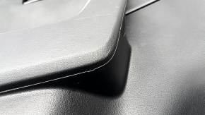 The door trim panel, rear left, Toyota Rav4 19-24, is black, the armrest is black leather, the insert is black plastic, the molding with the handle is gray, scratches are visible.