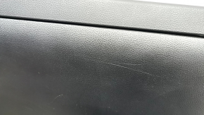 The glove compartment of a Toyota Rav4 19-21 is black and has scratches.