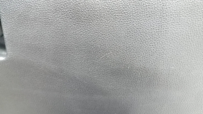 The glove compartment of a Toyota Rav4 19-21 is black and has scratches.