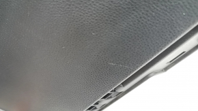 The glove compartment of a Toyota Rav4 19-21 is black and has scratches.