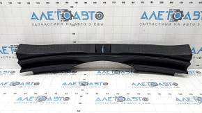 The trunk opening trim for a Toyota Rav4 19-24 is black, with scratches and whitened plastic.